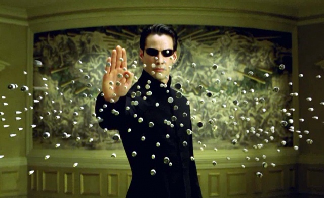 a man in black shirt and sunglasses holding up his hand with bubbles coming out of it