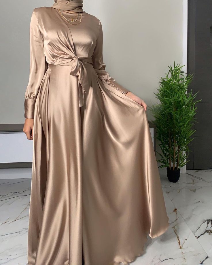 ÁADORN ATTIRE on Instagram: “Can we take a moment to appreciate how gorgeous this dress is?? 😍 I’m obsessed with anything taupe/champagne gold at the moment!…” Islamic Fashion Dresses, Soiree Dress, Mode Abaya, Women Dresses Classy, Modest Bridesmaid Dresses, Modesty Fashion, Muslim Fashion Dress, Muslim Fashion Outfits, Muslimah Fashion Outfits