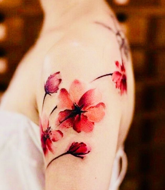 a woman's arm with flowers painted on it