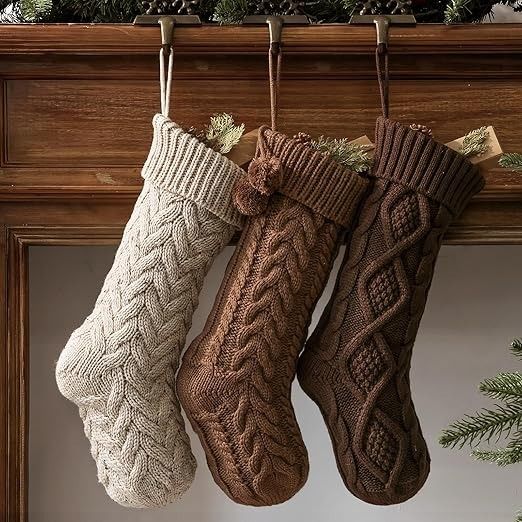 three knitted stockings hanging from a mantel