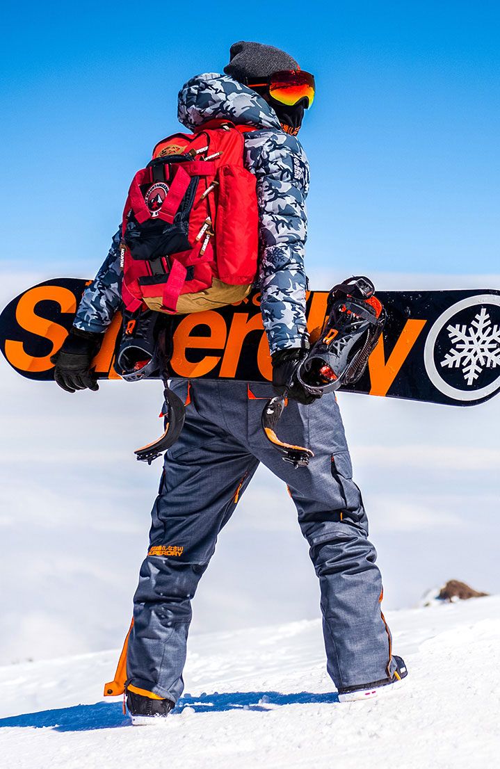 a man carrying a snowboard on his back