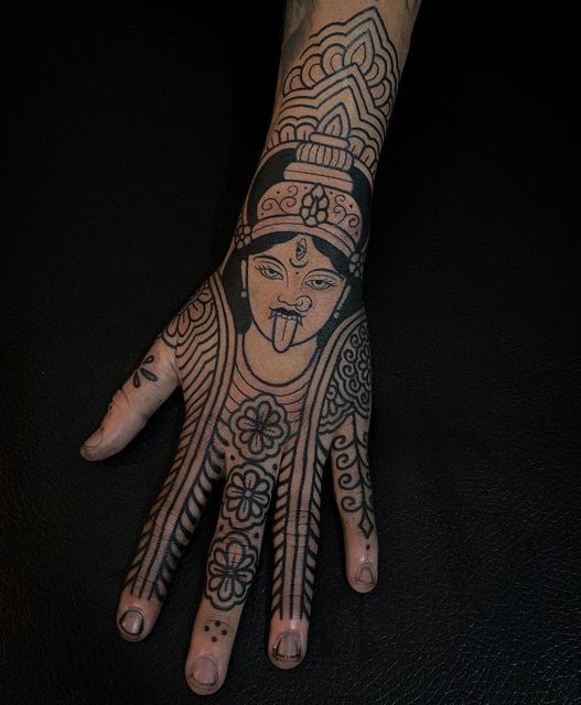 a person with tattoos on their arm and hand