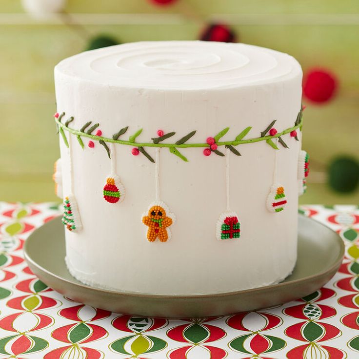 a white frosted cake decorated with christmas decorations