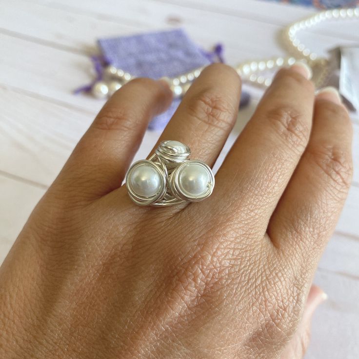 "Beautiful and unique Silver Wire Pearl Ring, ideal for an special gift for her,  This ring is made with a 3mm round pearl and wrapped in non tarnish silver wire. This ring is made to order in the size of your choice.  I T E M ~D E T A I L S Materials: Silver Plated Wire, Pearls. Size: See Variations. You can also ask for a different wire color, silver or rose gold tone are available (See variations). Thank you for visiting my product. You can see more amazing designs in my shop clicking here: h Unique Pearl Promise Ring, Nickel Free Elegant Crystal Ring For Jewelry Making, Wire Wrapped Pearl Wedding Ring, Elegant Wire Wrapped Toe Rings, Elegant Nickel-free Stackable Rings For Wedding, Elegant Nickel-free Crystal Ring For Jewelry Making, Elegant Nickel-free Stackable Wedding Rings, Dainty Hand-wrapped Silver Rings, Elegant Hand Wrapped Rings For Anniversary