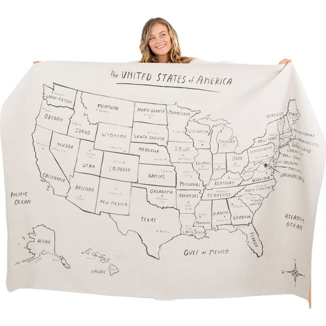 a woman holding up a map of the united states with names and cities on it