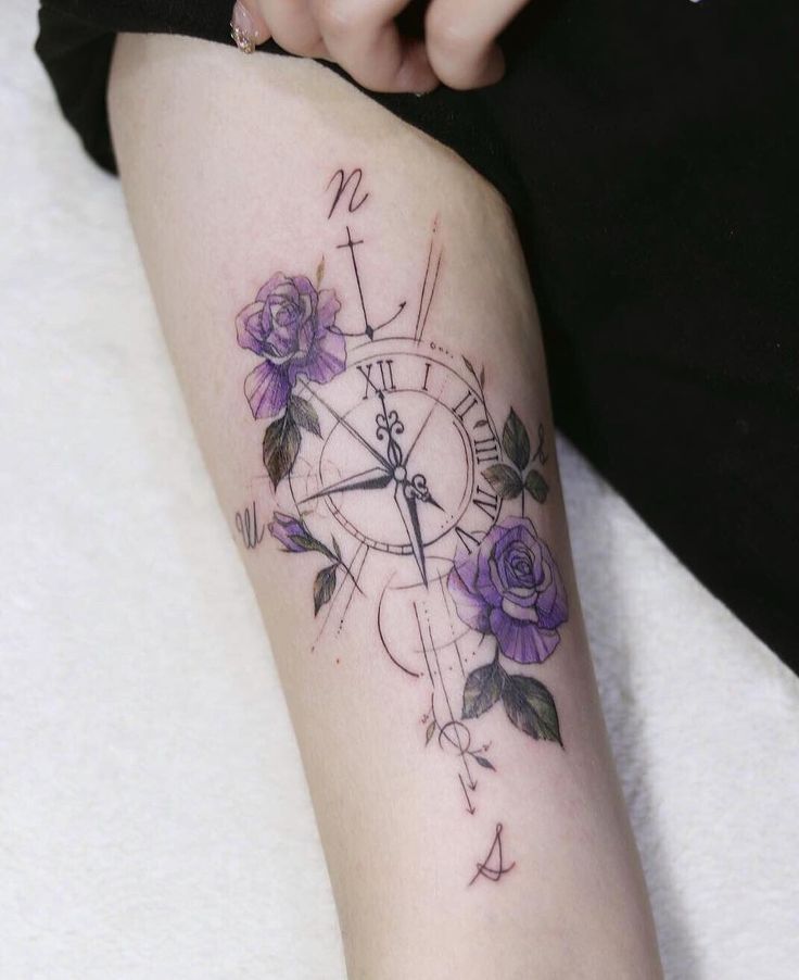 a woman with a tattoo on her arm holding a clock and roses in the middle