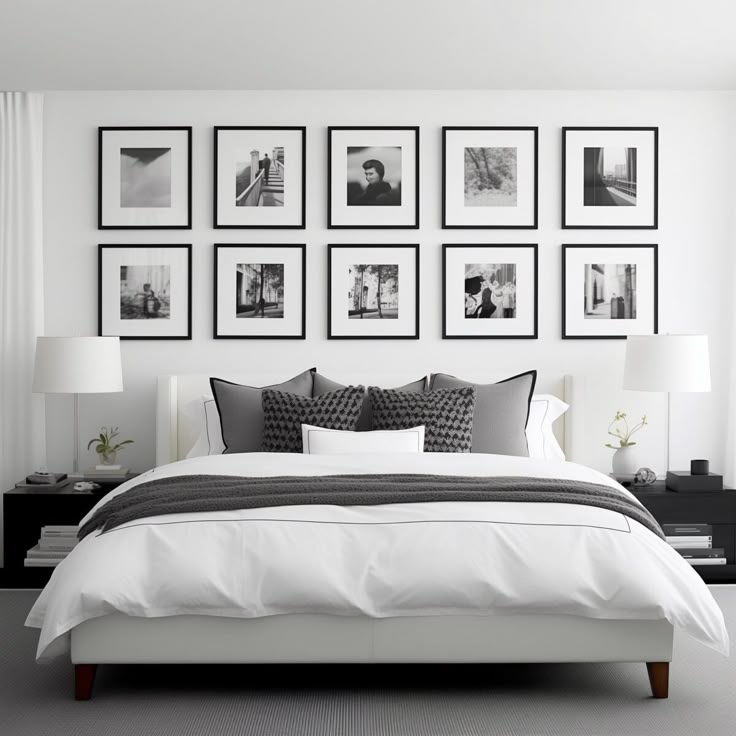 a bedroom with white walls and pictures on the wall above the bed, along with black and white decor