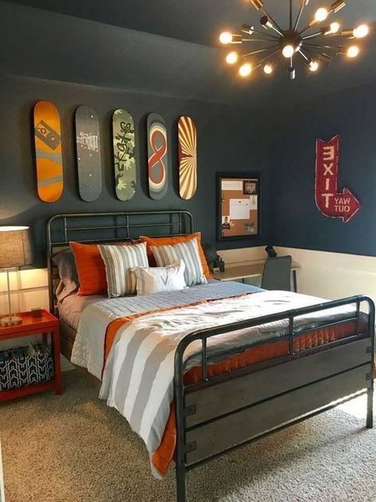 a bed room with a neatly made bed and lots of skateboards on the wall