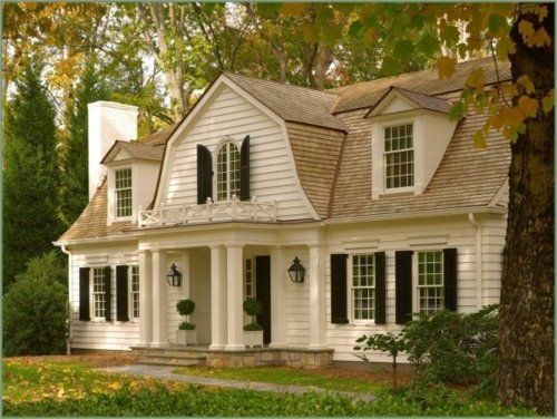 a white house with black shutters and windows