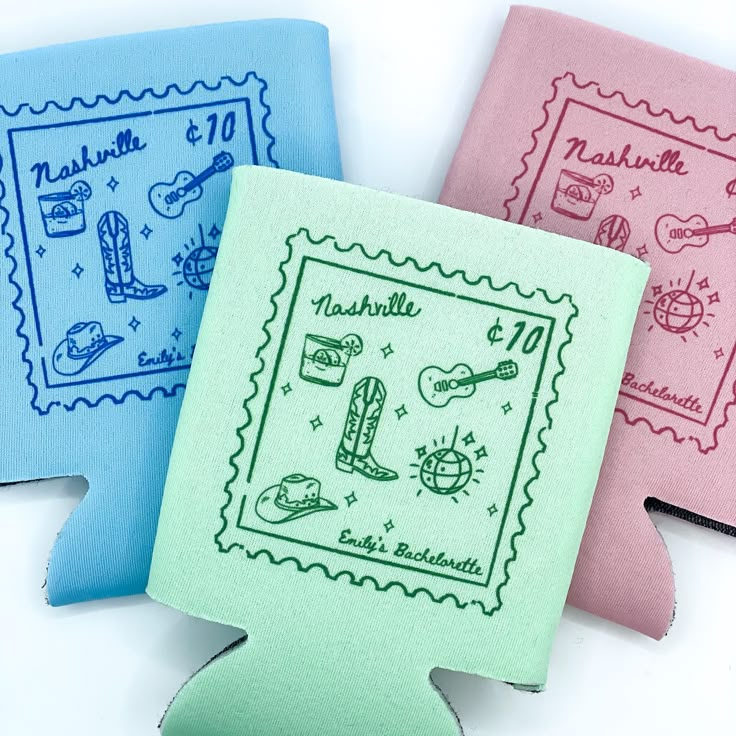 three different colored envelopes with stamps on the front and one in blue, pink, and green