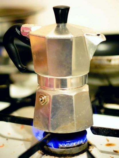 a stove top with a coffee pot on it