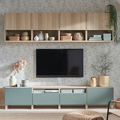 a living room filled with furniture and a flat screen tv on top of a wooden entertainment center