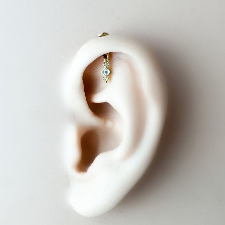 an ear with a single diamond in it