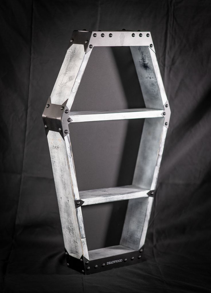 a metal shelf sitting on top of a black background with the bottom section removed from it