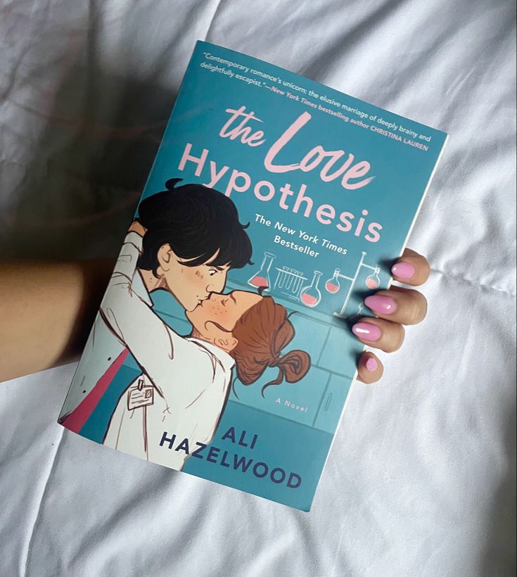 the love hypothhesis book is being held by a woman's hand