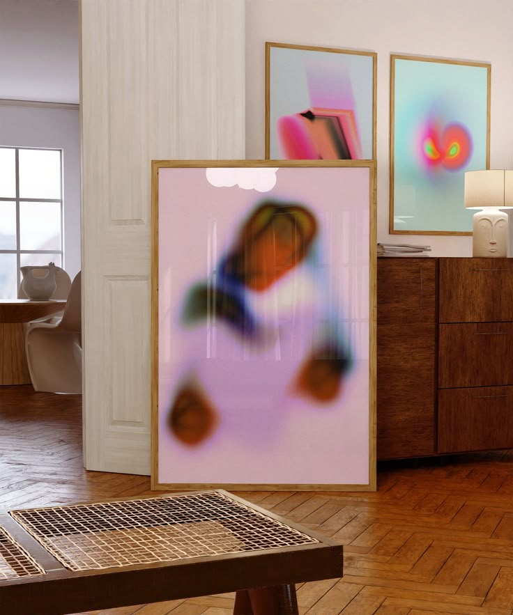 an art work is displayed in the middle of a room with wooden floors and white walls