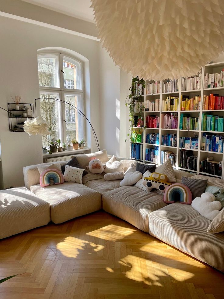 a living room filled with lots of furniture and bookshelves