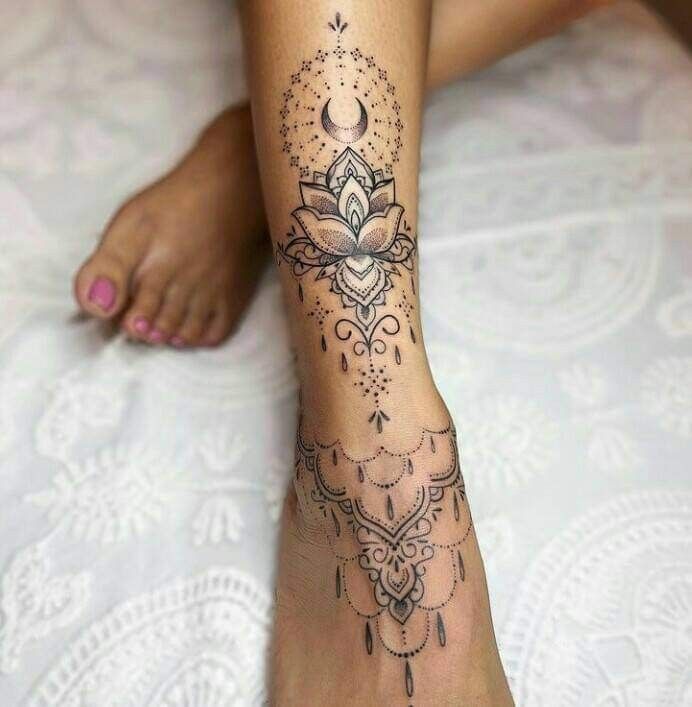 a woman's foot with a tattoo on the top and bottom of her leg