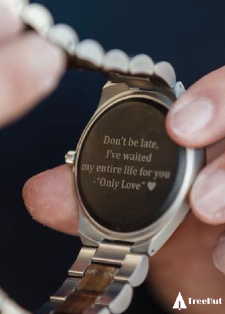 a person holding onto a watch with a quote on the front and back of it