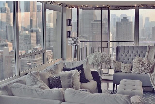 an instagram photo of a living room with couches and windows in the background