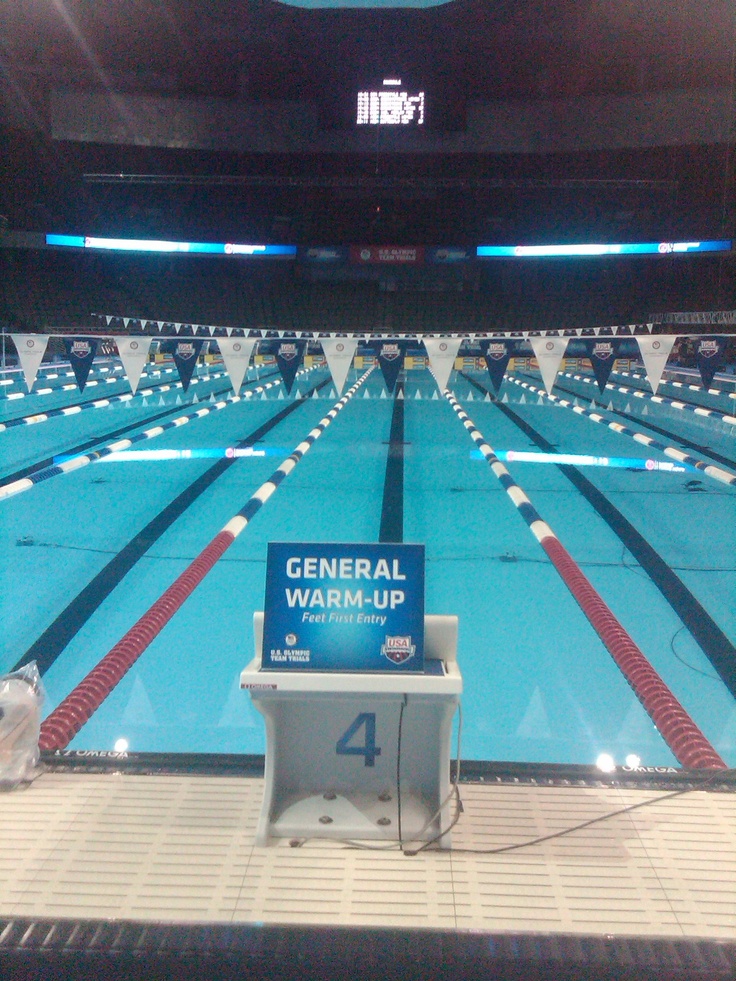 an empty swimming pool with the number four on it's back wall and blue water