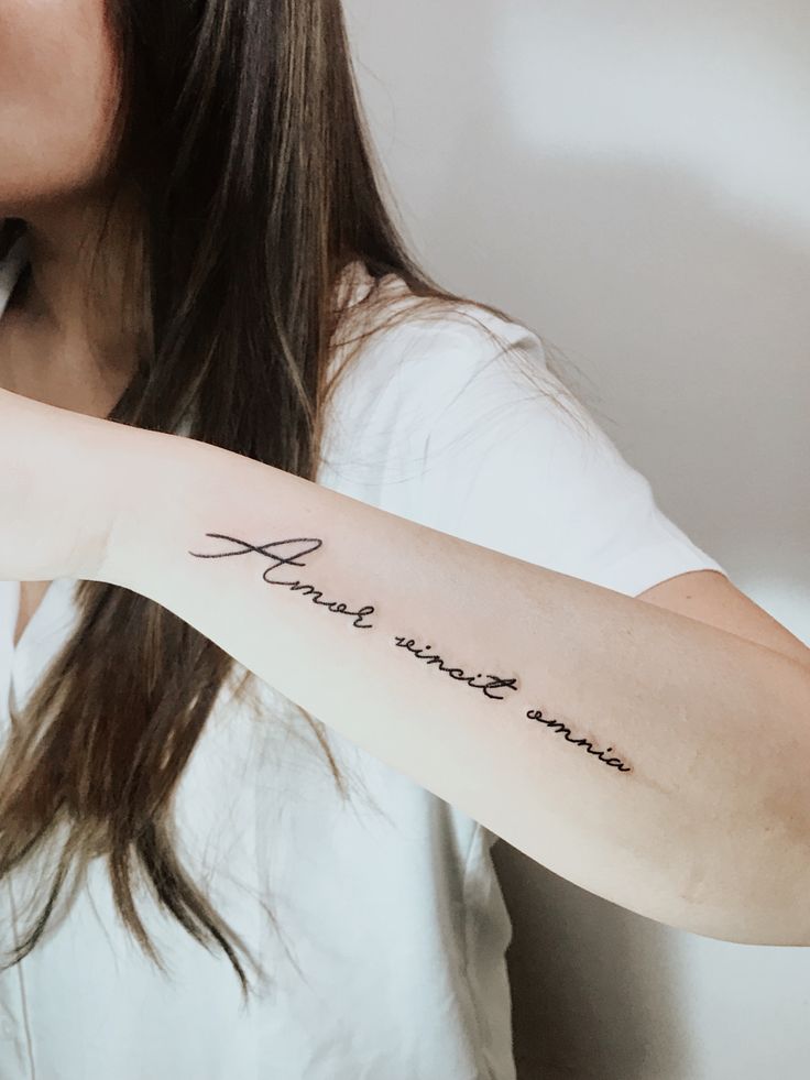 a woman with a tattoo on her arm that says, thank you're mine