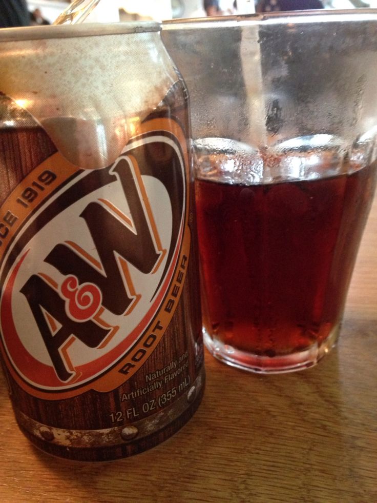 a close up of a bottle of beer next to a glass on a wooden table