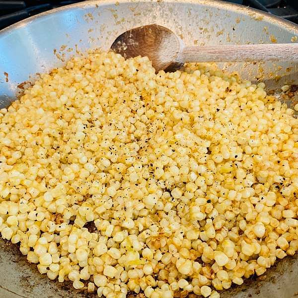 corn is being cooked in a pan on the stove