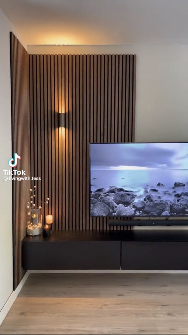 a flat screen tv sitting on top of a wooden entertainment center in a living room