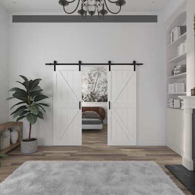 a living room with white walls and wooden floors, an open door leading to the bedroom