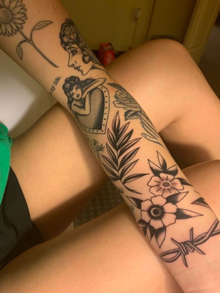 a woman's arm with tattoos on it