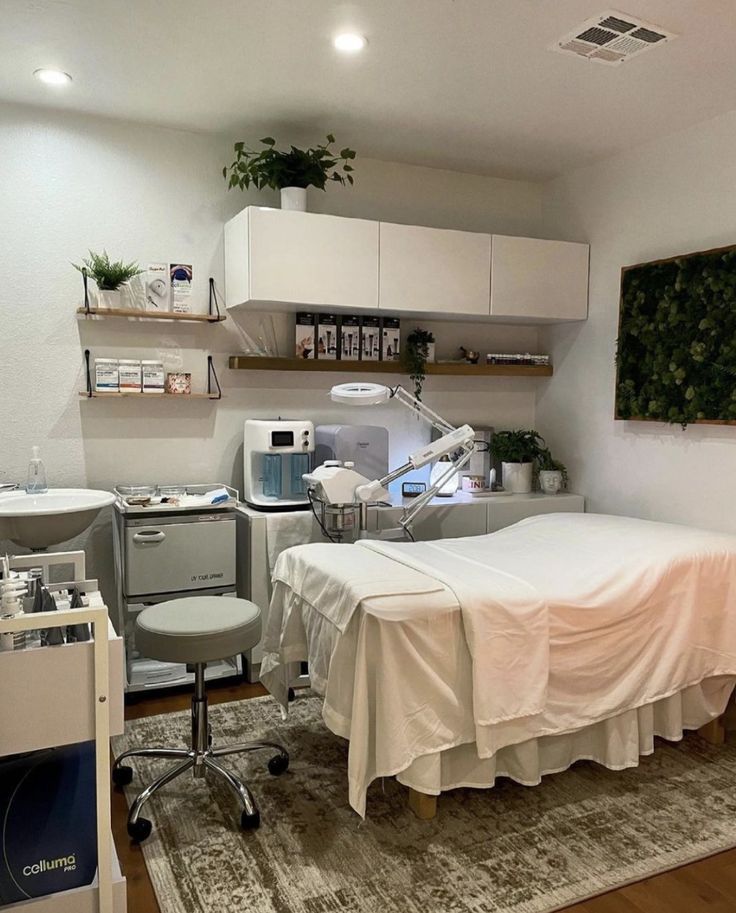 a hospital room with a bed, desk and medical equipment