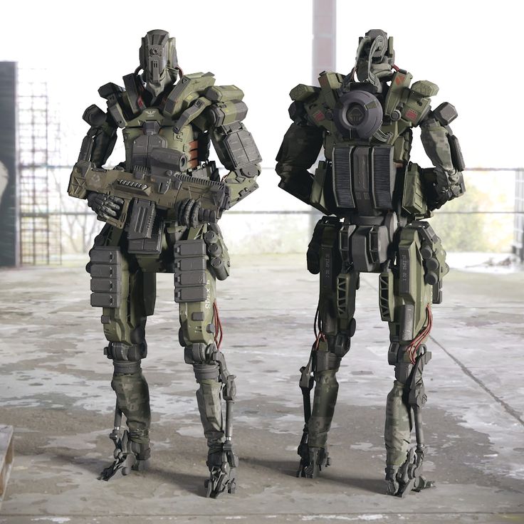 two sci - fi robots standing next to each other