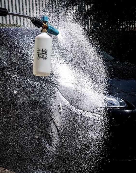 a car is being sprayed with water by a fire extinguisher on the hood