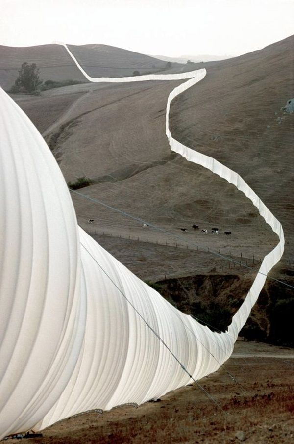 there is a curved white structure in the desert