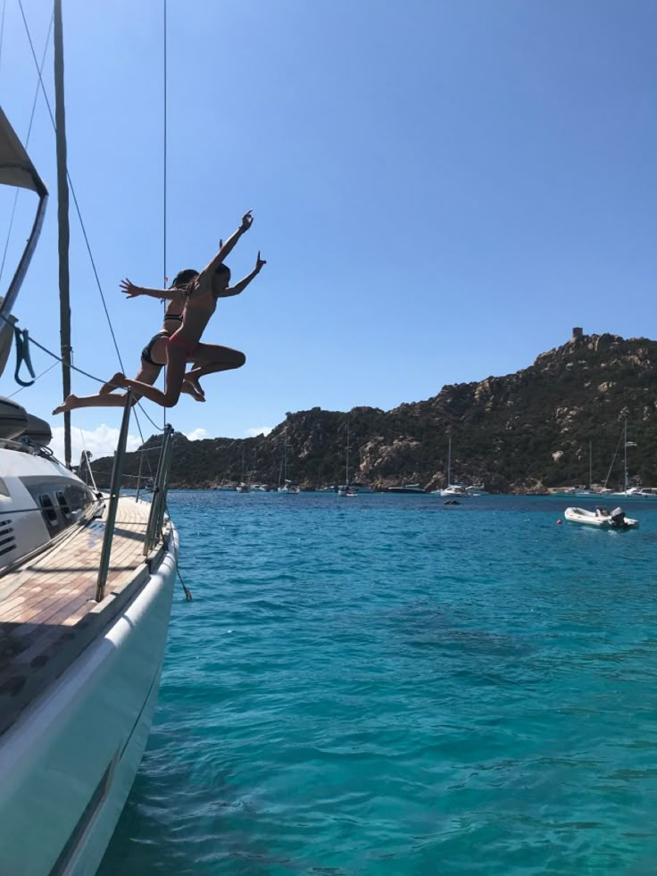 a person jumping off the side of a boat