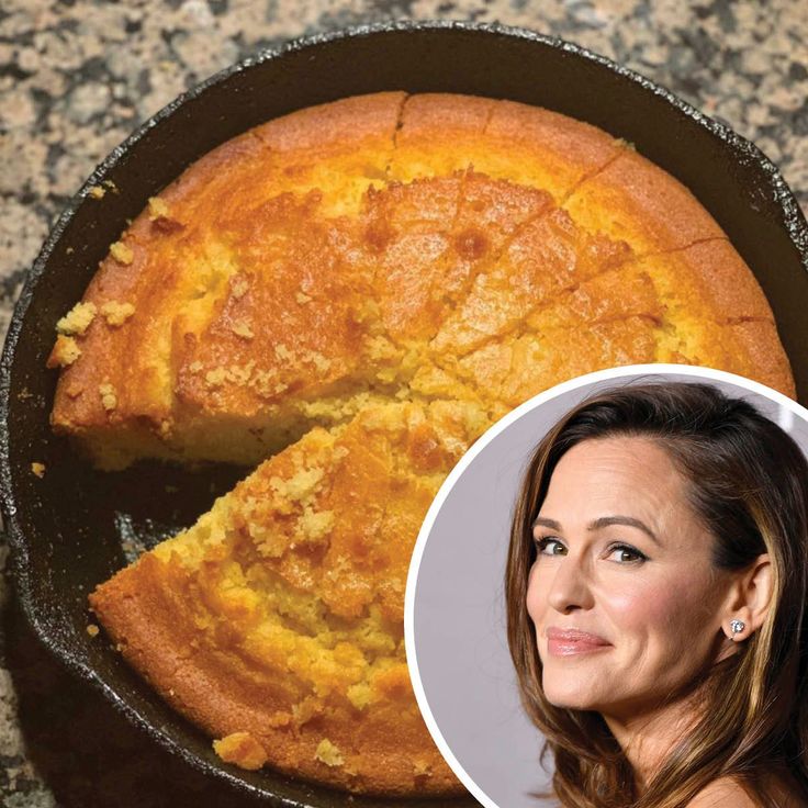 a woman standing next to a cake in a pan