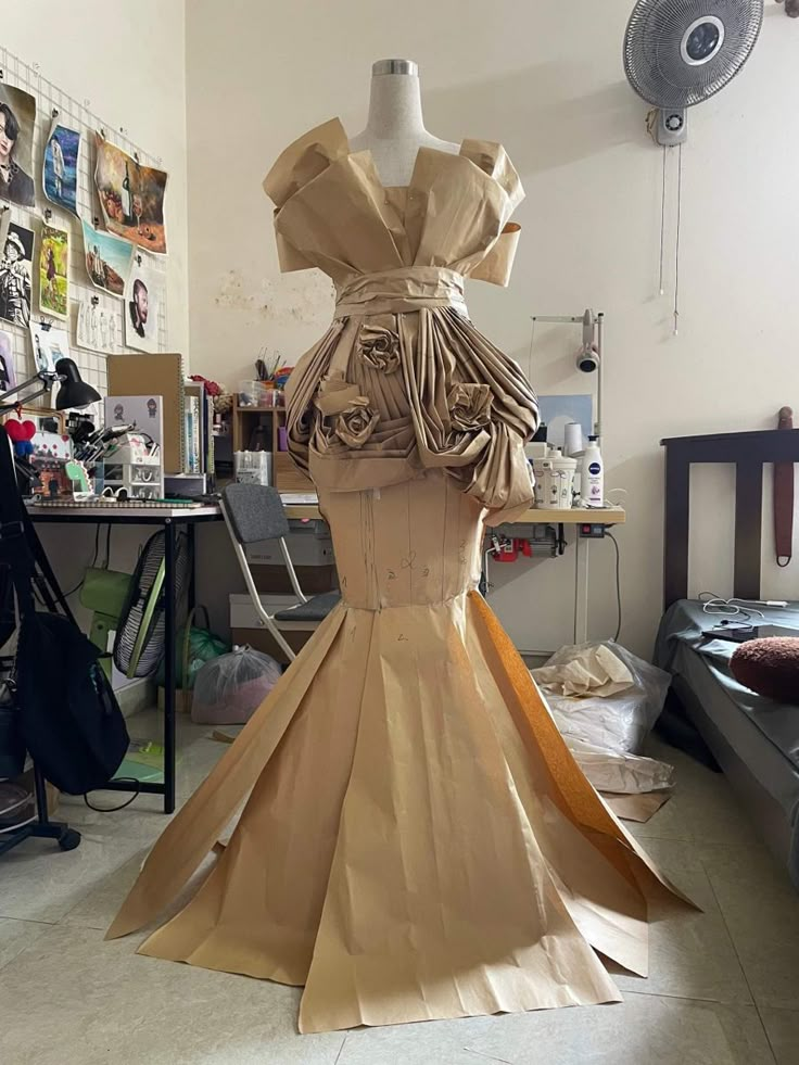 a dress made out of paper sitting on top of a table