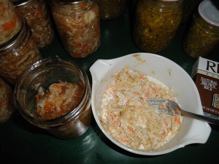 a table topped with lots of food and jars filled with different types of foods on top of it