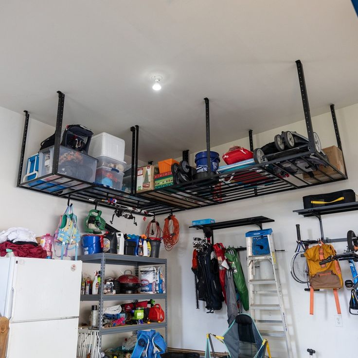 a garage with various items and tools hanging from the ceiling, including an overhead rack