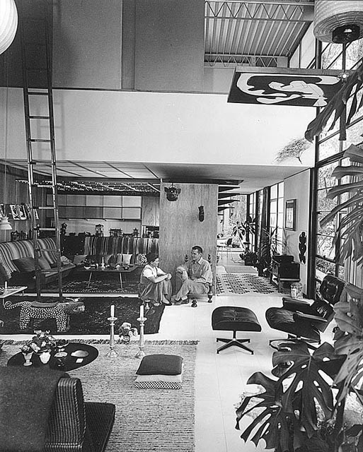 an image of a magazine cover with people sitting in the living room and dining area