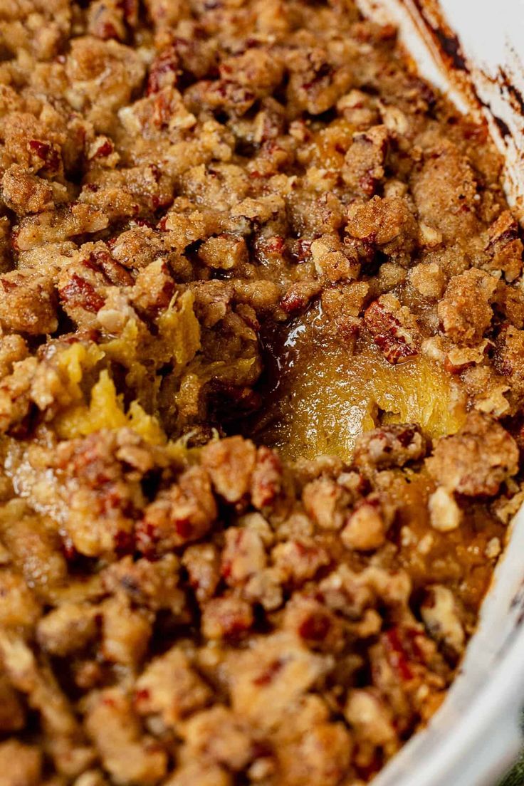 a casserole dish filled with fruit and crumbled toppings