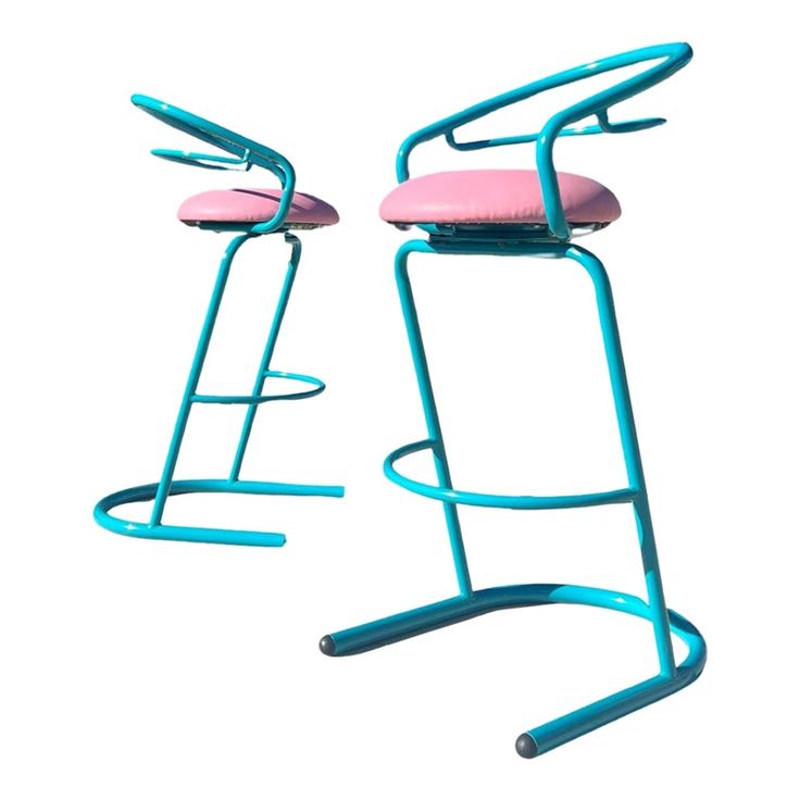 two pink and blue stools sitting next to each other