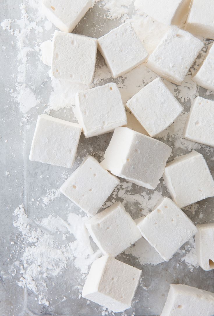 several pieces of tofu sitting on top of a table covered in powdered sugar