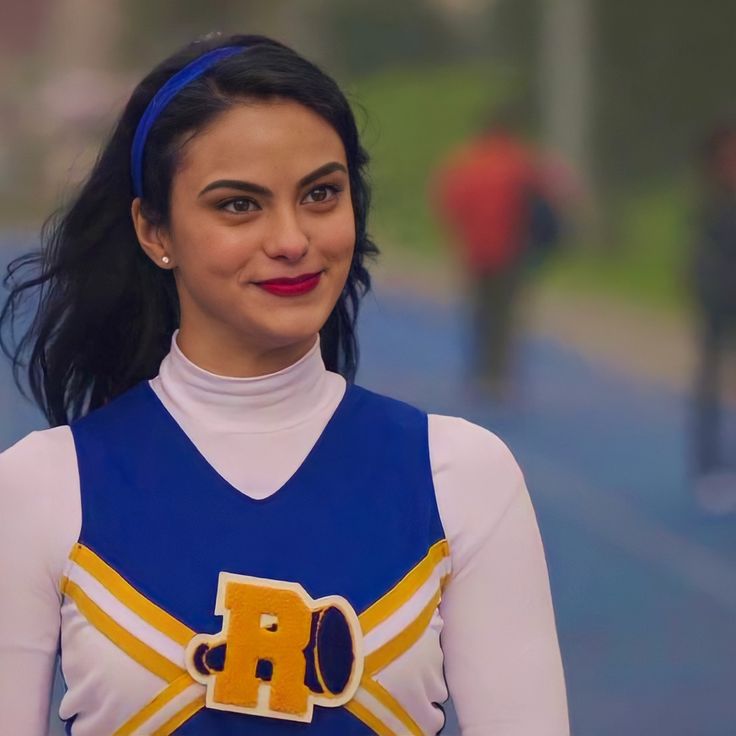 a woman wearing a cheerleader outfit and smiling