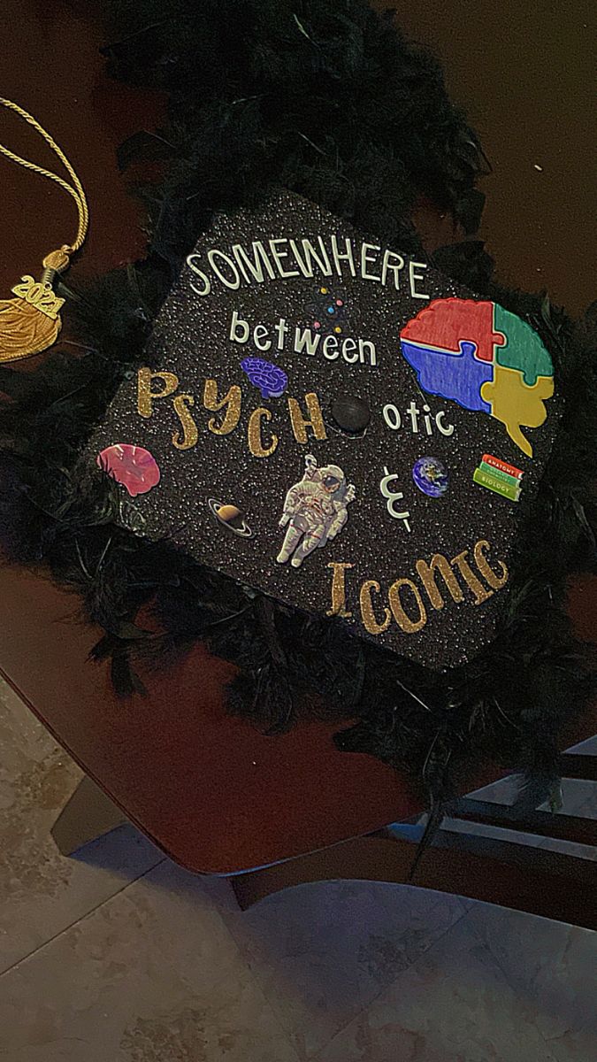 a black graduation cap that has been decorated with words and other things on the front