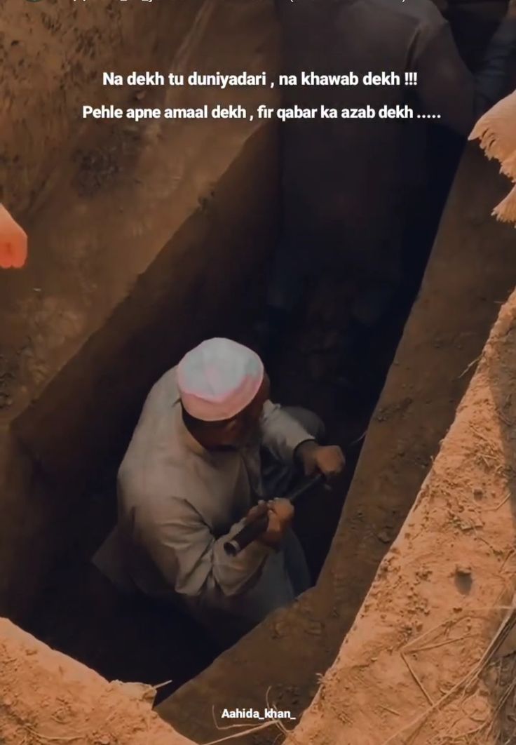 a man is digging in the ground with a hammer and wearing a turban