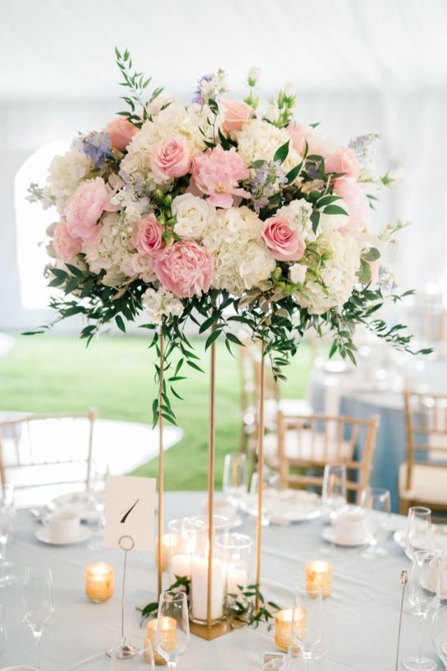 a tall vase filled with pink and white flowers