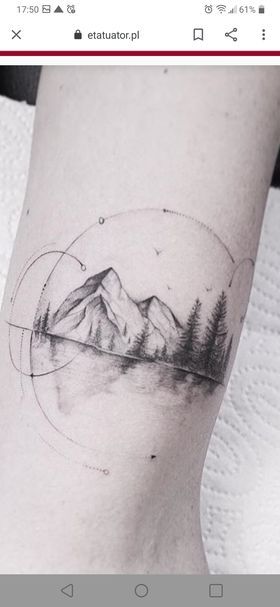 a tattoo with mountains and trees on the side of the leg, in black and white