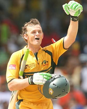 a man in yellow and green uniform holding up his hands while walking towards the camera